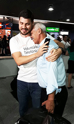 Voluntário Thiago à esquerda, abraça Severino na chegada deste ao aeroporto no Recife